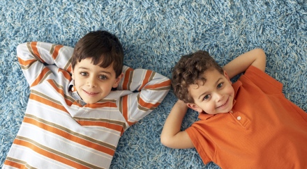 boys laying on clean carpet smiling
